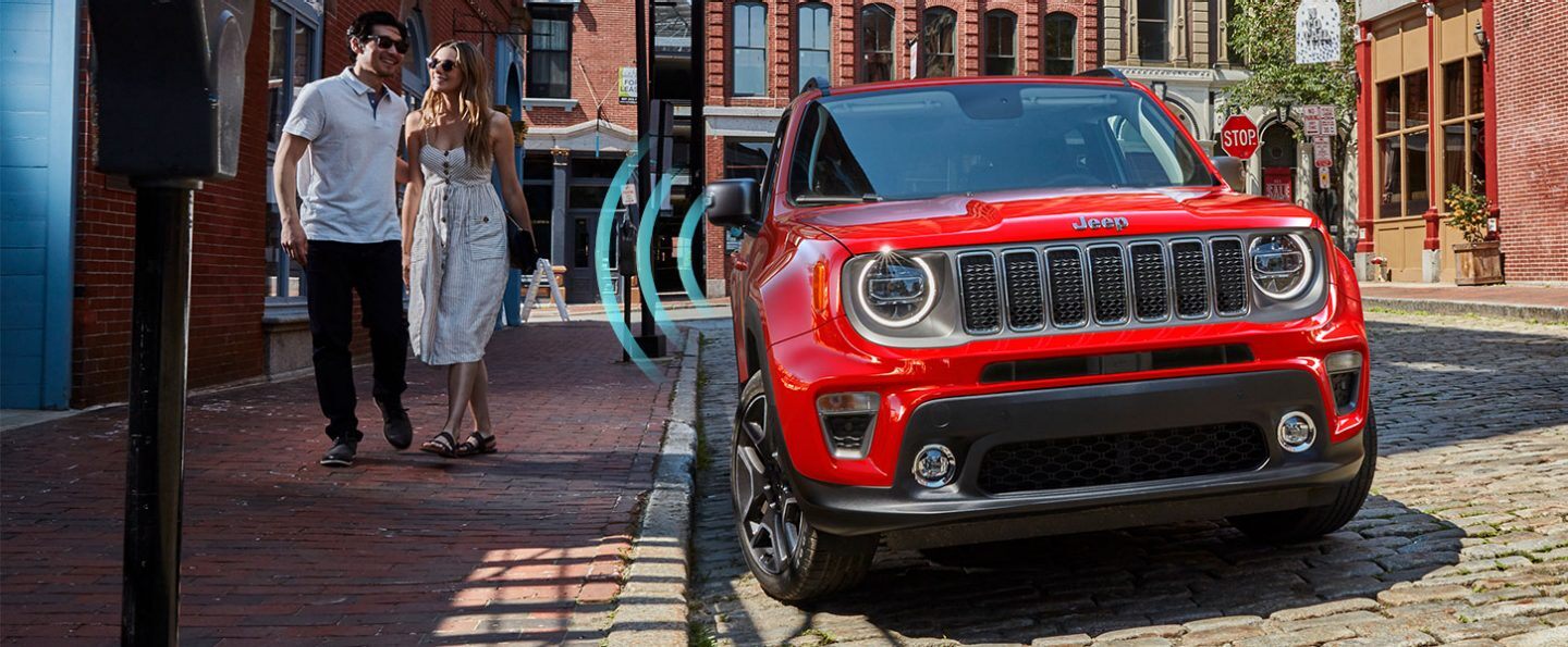 The 2021 Jeep Renegade parked at the curb, with sensor lines emanating from the door as it detects the owner approaching.