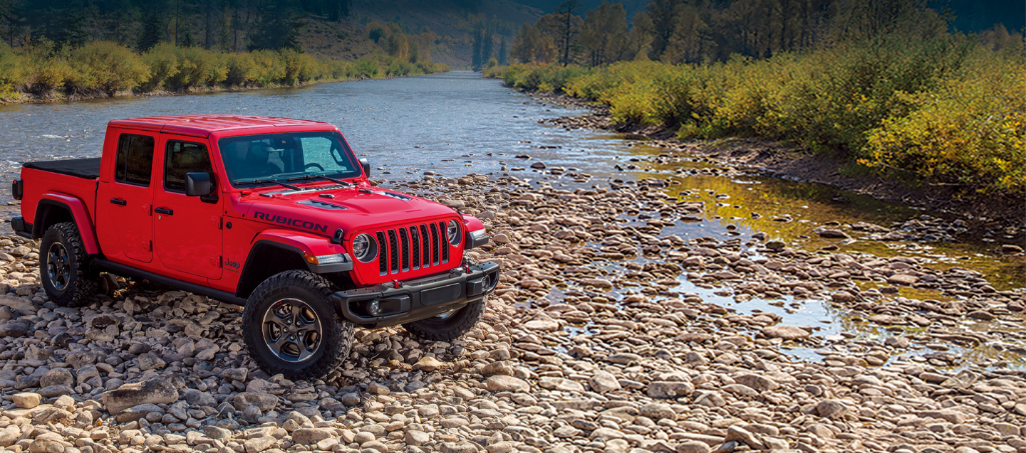 A view of a 2021 Jeep Gladiator  parked near the river.