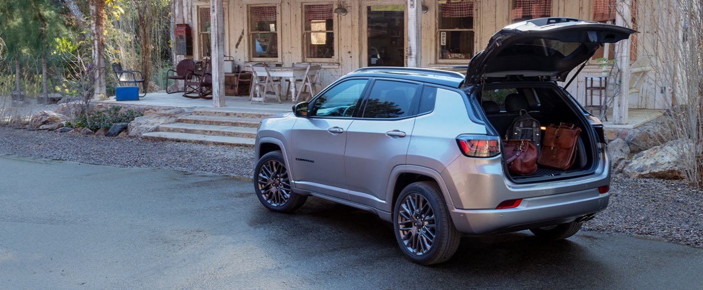 The 2022 Jeep Compass High Altitude with its liftgate open to reveal its cargo compartment filled with luggage.