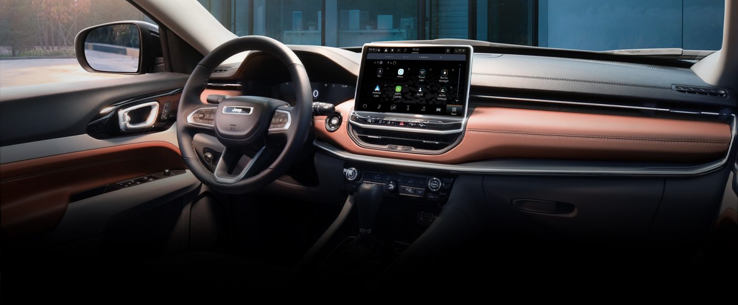 The steering wheel, Uconnect touchscreen and dashboard in the Jeep Compass.