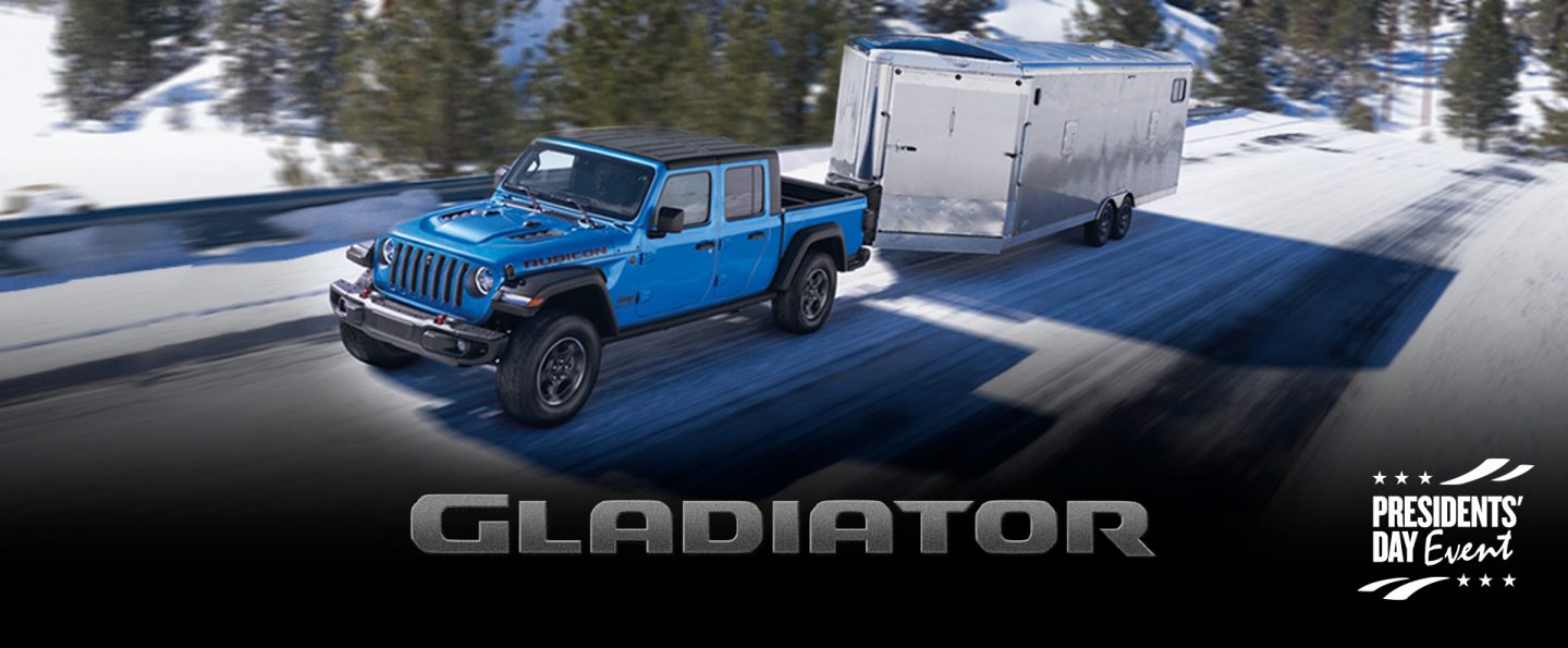 The 2022 Jeep Gladiator Rubicon towing an enclosed trailer on a snowy mountain road. The Presidents Day Event logo.